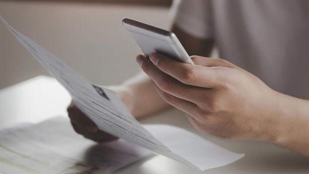 Person scanning a document with mobile phone